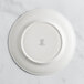 A white RAK Porcelain plate with an embossed logo.