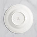 A white RAK Porcelain deep plate with an embossed crown logo.