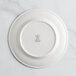 A RAK Porcelain ivory flat plate with an embossed crown logo.