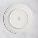 A white RAK Porcelain flat plate with an embossed design.