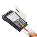 A hand using a Controltek USA card reader cleaning card to clean a credit card swipe.