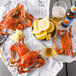 Steamed Chesapeake Blue Crabs with lemons on newspaper.