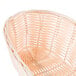A Tablecraft oblong rattan-like bread basket with a handle.