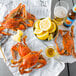 Steamed Chesapeake blue crabs on newspaper with lemons.