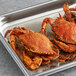 A tray of small to medium cooked female blue crabs.