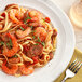 A plate of pasta with shrimp and tomatoes seasoned with Regal Salt-Free Cajun Seasoning.