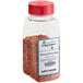 A clear container of Regal Homestyle Pork Rub seasoning with a red label and lid.