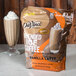 A bag of DaVinci Gourmet Vanilla Latte Mix next to a bag of coffee.