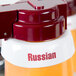 A close up of a Tablecraft white plastic Russian salad dressing dispenser collar with maroon lettering.