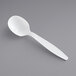 A Visions white plastic spoon on a gray surface.