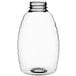 A clear plastic Classic Queenline honey bottle with a lid.