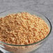 A bowl of Bob's Red Mill Textured Vegetable Protein on a table.