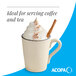 A cream white matte stoneware mug filled with a whipped topping and garnished with a cinnamon stick.