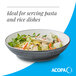 A large midnight blue matte stoneware pasta bowl filled with salad.