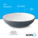 A deep blue matte stoneware pasta bowl with a glossy white interior and dark banded edge.