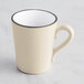 An Acopa Embers cream white stoneware mug with a handle.