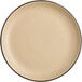 An Acopa Harvest Tan matte coupe stoneware plate with a black rim.