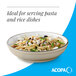 A cream white matte stoneware pasta bowl filled with pasta and vegetables.