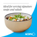 A tan matte stoneware bowl filled with salad, ideal for serving soups and salads.