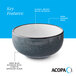 A stoneware bowl with a deep blue matte speckled exterior, glossy white interior, and a dark banded edge.