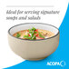 A cream white matte stoneware bowl with a speckled finish, ideal for serving soups and salads.
