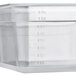 A translucent plastic Vigor food pan with measurements on it and a lid, on a counter.