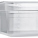 A translucent plastic food pan with a lid on a counter.