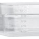 A clear plastic Vigor food pan with measurements.