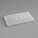 A translucent polypropylene plastic container lid with a handle and a square notch in the middle.