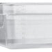 A clear Vigor plastic food pan with measurements on it.