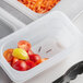 A Vigor translucent plastic drain tray with tomatoes in it.