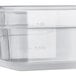 A translucent polypropylene food pan with a clear lid.