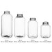 A row of clear plastic 16 oz. Skep PET sauce/honey bottles with white lids.