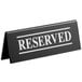 A black Tablecraft plastic "Reserved" sign with white text on both sides.