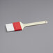 A white and red Choice pastry/basting brush with plastic handle.