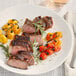 A plate of steak and tomatoes seasoned with Regal Texas-Style Steak Seasoning.