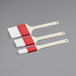 A Choice 3-piece pastry and basting brush set with white bristles and red handles.