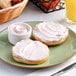 A plate with bagels and Philadelphia Strawberry Cream Cheese Spread on it.
