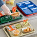 A left hand wearing a plastic glove preparing a blue melamine tray with 6 compartments of food.