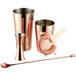 A set of copper Acopa cocktail shakers and a cocktail spoon.