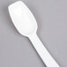 A Carlisle white plastic salad bar spoon.