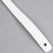 A white plastic Carlisle salad bar spoon with a hole in the handle.