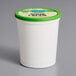 A white container of Follow Your Heart Dairy-Free Vegan Sour Cream with a green lid.