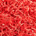 A pile of Spring-Fill Red Crinkle Cut paper shred.