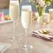 Two Della Luce Maia champagne flute glasses on a table.