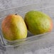 Two mangoes in a plastic container.
