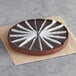 A Sweet Street Desserts flourless chocolate torte with white paper strips on top.