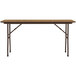 A brown Correll rectangular folding table with a medium oak top and metal legs.