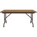A brown rectangular Correll folding table with metal legs and a wood surface.