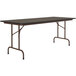 A rectangular Correll folding table with a walnut top and brown frame.